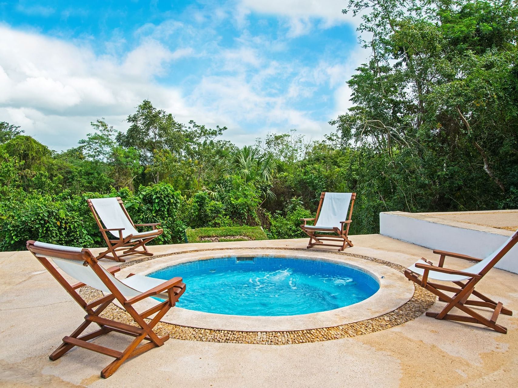 Outdoor jacuzzi with lounge chairs at La Coleccion Resorts