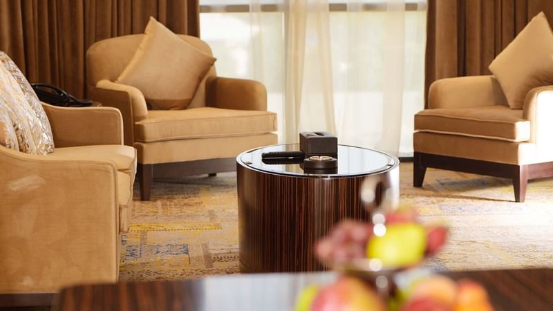 Living room with couches & carpeted floors in Ambassador Suite at Warwick Al Khobar