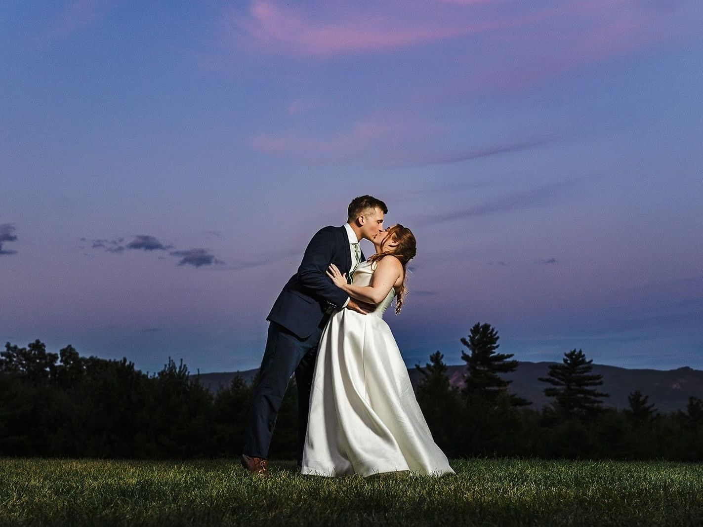 a couple embraces at sunset on their wedding day 