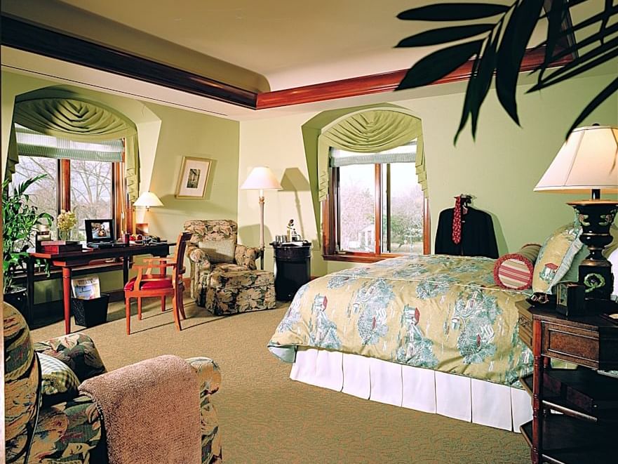 Executive King Room featuring a green color scheme, floral decor, a desk, and large windows at The Rose Hotel