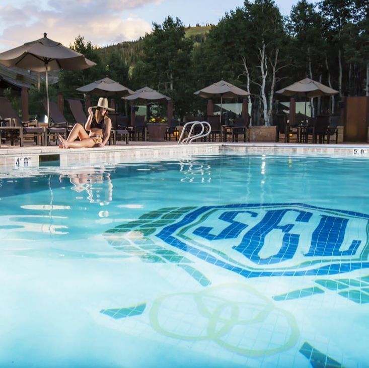 Lady posing by the outdoor pool at Stein Eriksen Lodge