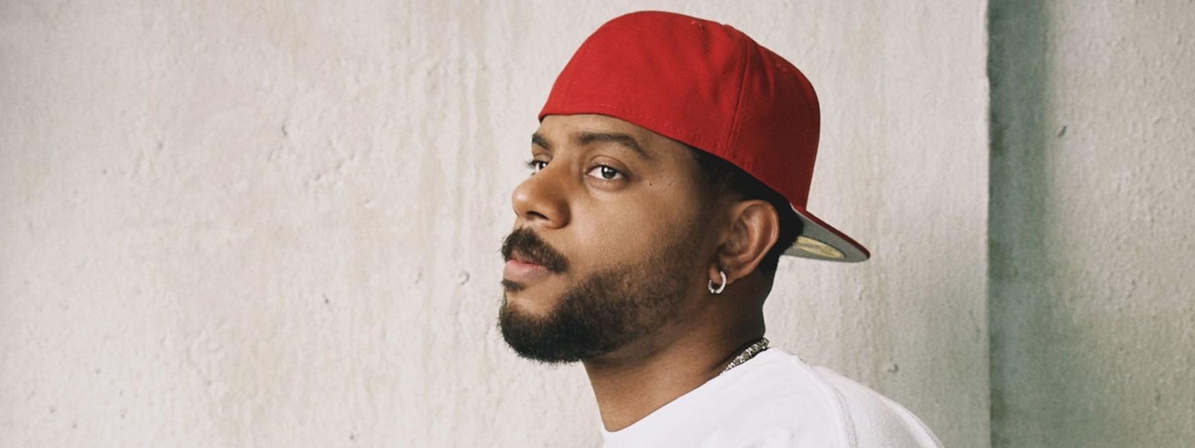 Man in red cap and white shirt gazing to the side for Bryson Tiller Presents: The Neo Trapsoul Tour 2026