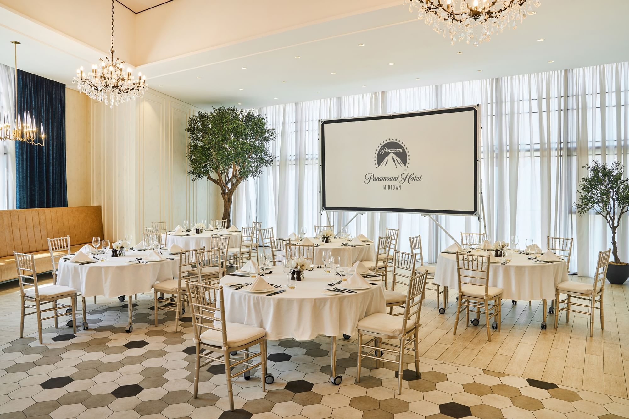 Dining table arrangements and gold finishings in the Paparazzi restaurant event room at Paramount Hotel Midtown