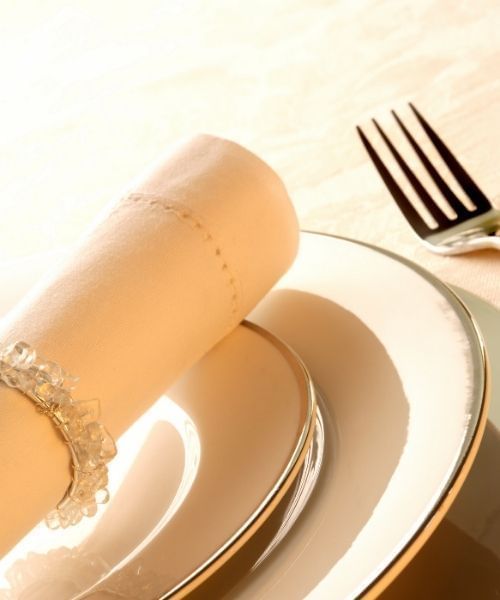 Table setting with white plates, napkins, and a fork on a tablecloth at Sunway Hotel Big Box