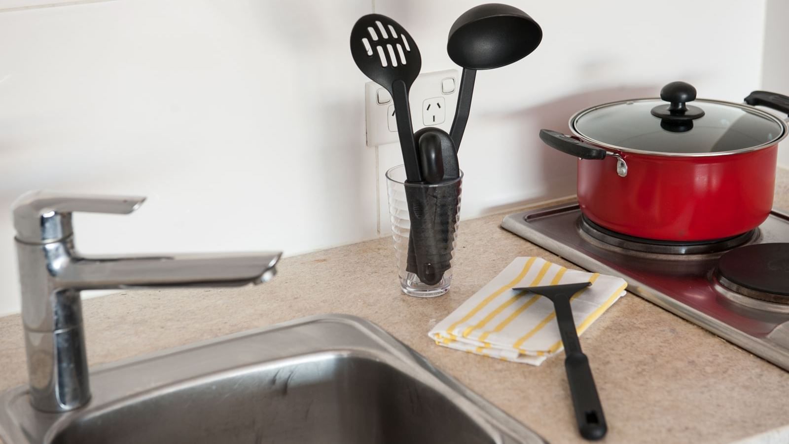 Typical kitchen featuring sink, stove, fridge & microwave (not featured)- kitchen utensils can be purchased via our online shop, Your Shop