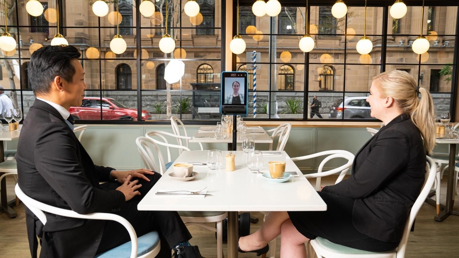 Two people having an online meeting in a restaurant at Pullman King George Square