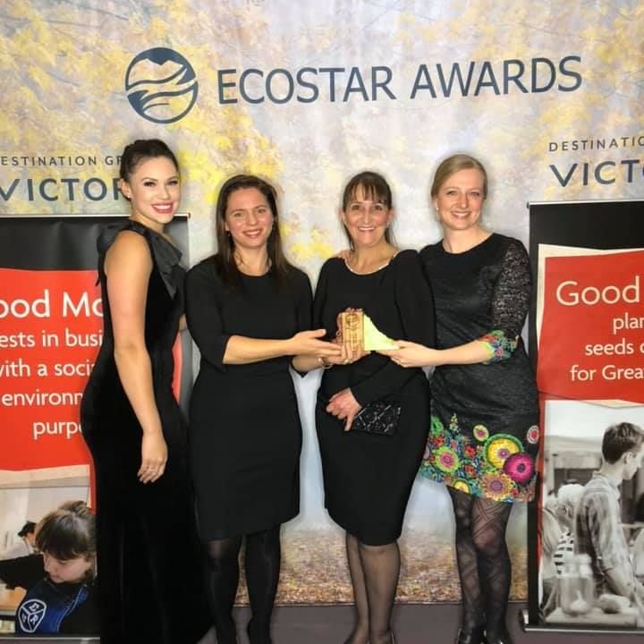 Staff management posing & holding an award in Greenest Lodge Ecostar Awards at Pendray Inn & Tea House