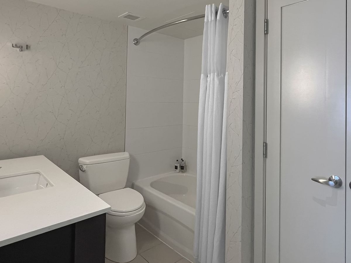 Bathroom with toilet, mirror, shower and sink