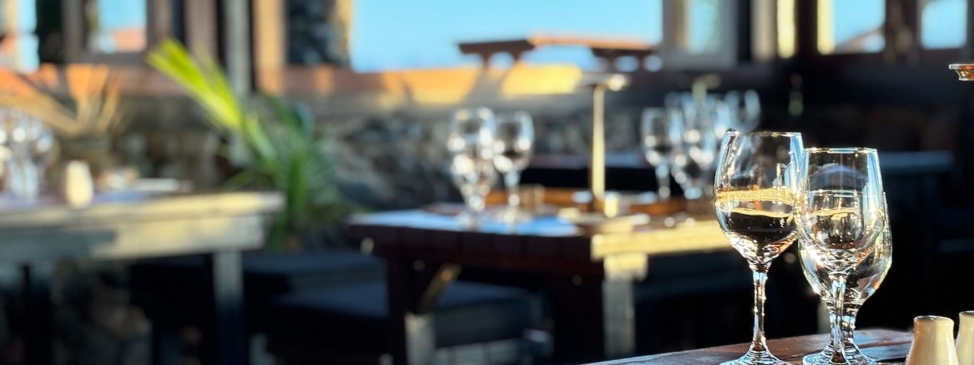 Set table with wine glasses and utensils at Wicked Walu restaurant in Korolevu at Warwick Fiji Resort and Spa