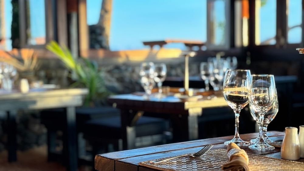 Set table with wine glasses and utensils at Wicked Walu restaurant in Korolevu at Warwick Fiji Resort and Spa.