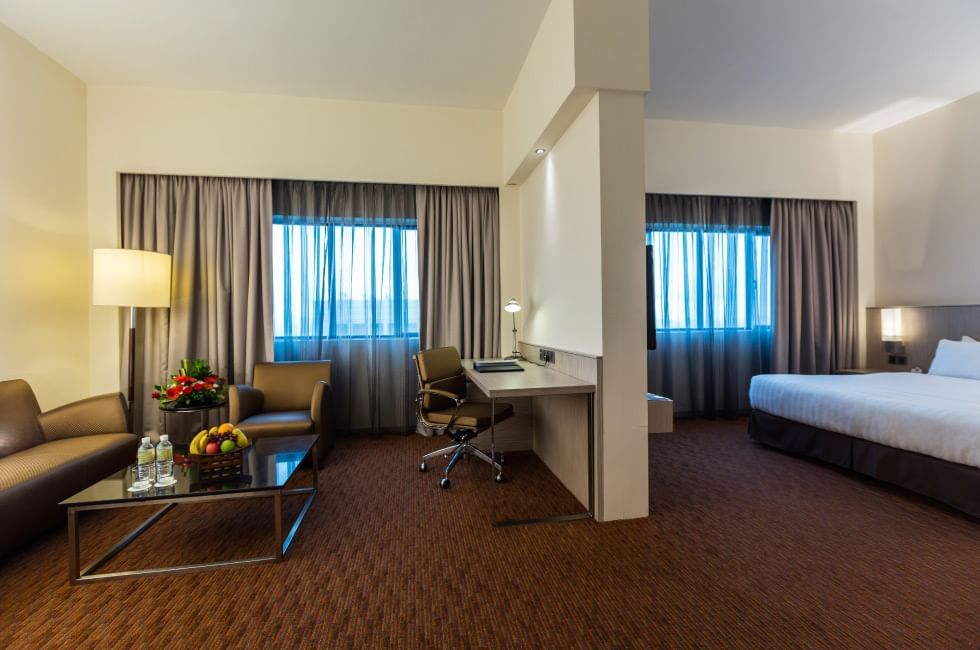 Living room with a work space and cozy loungers in Suite at Sunway Hotel Seberang Jaya