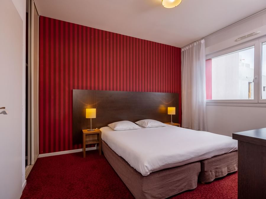 King bed in Kosy Appart Hotels at The Originals Hotels