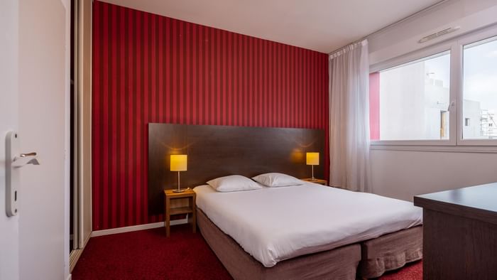 King bed in Kosy Appart Hotels at The Originals Hotels