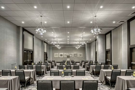 banquet room with tables and chairs set for conference