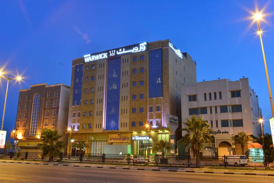 Naviti By Warwick Dammam facade by a city road under a blue evening sky 