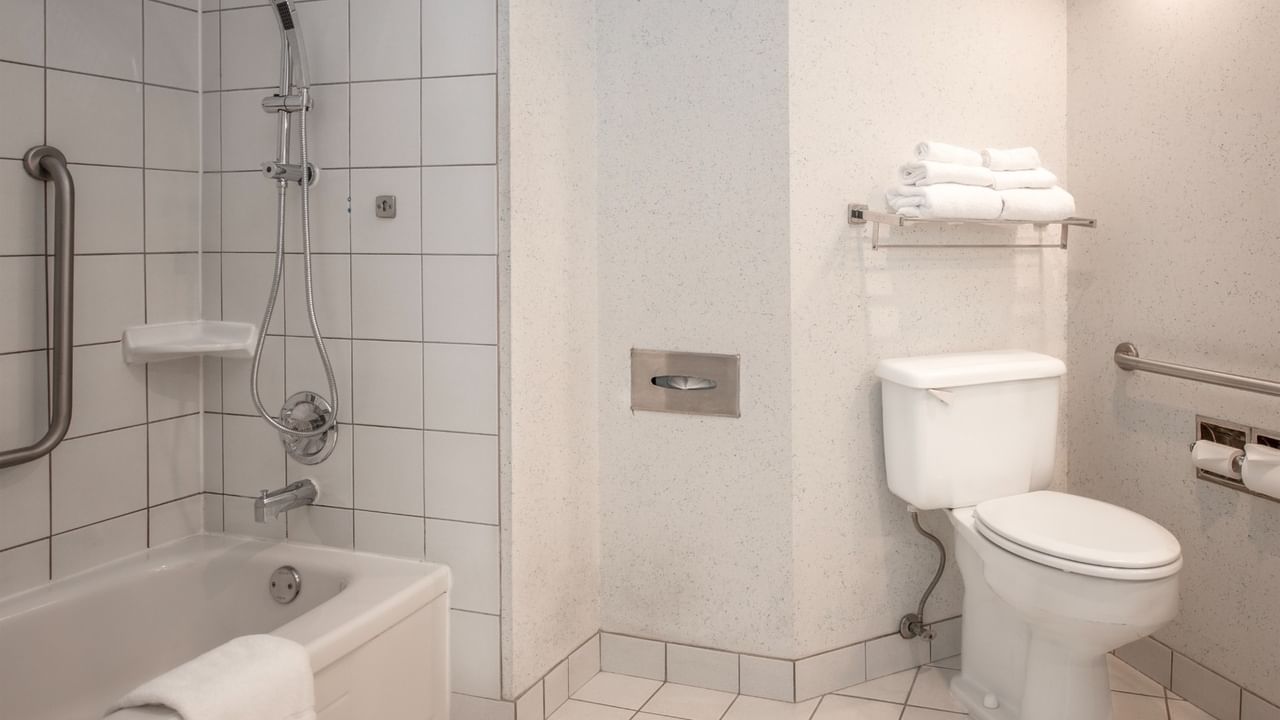Coast Accessible King bathroom with bathtub, showerhead, toilet at Coast Lonsdale Quay Hotel