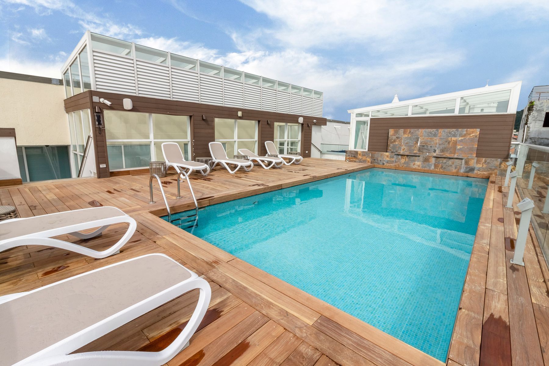 Outdoor Pool area with pool chairs at Central Hotel Panama
