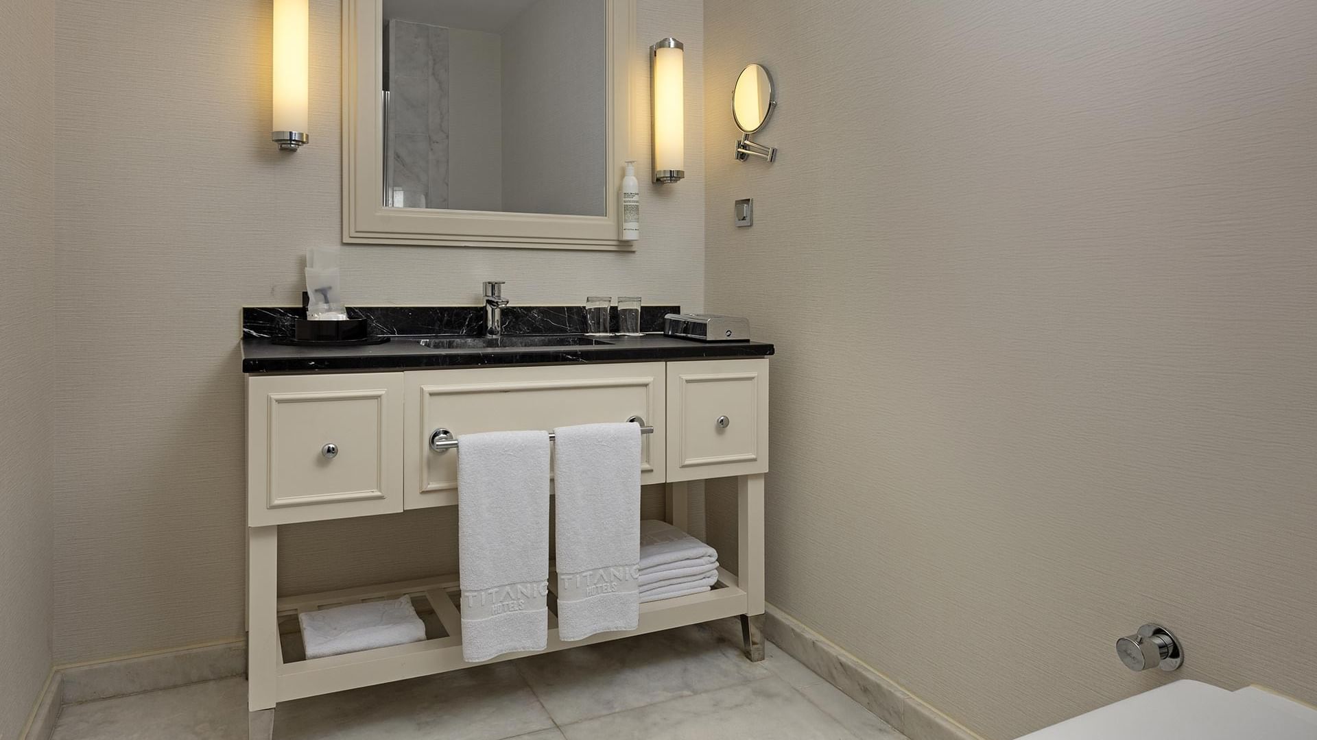 Standard Room bathroom with white towels and sink at Titanic Deluxe Golf Belek in Antalya.