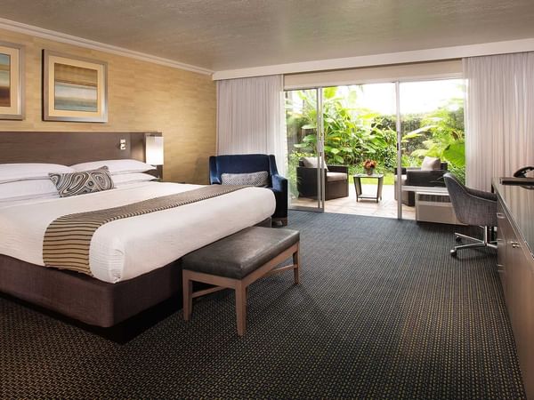 King bed in spacious hotel room with garden view