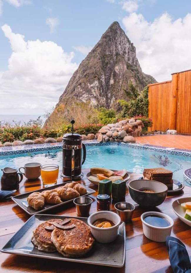 Breakfast by a pool overlooking a mountain peak at Ladera Resort