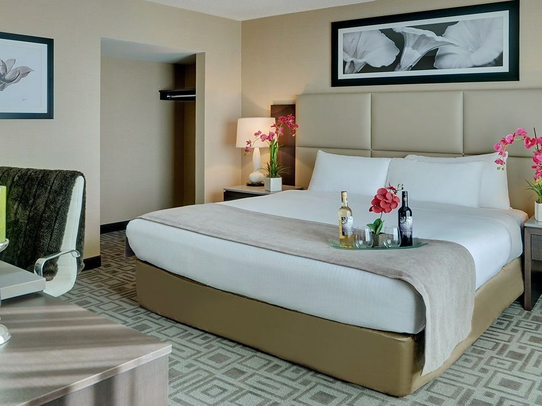 a tray of drinks on a bed