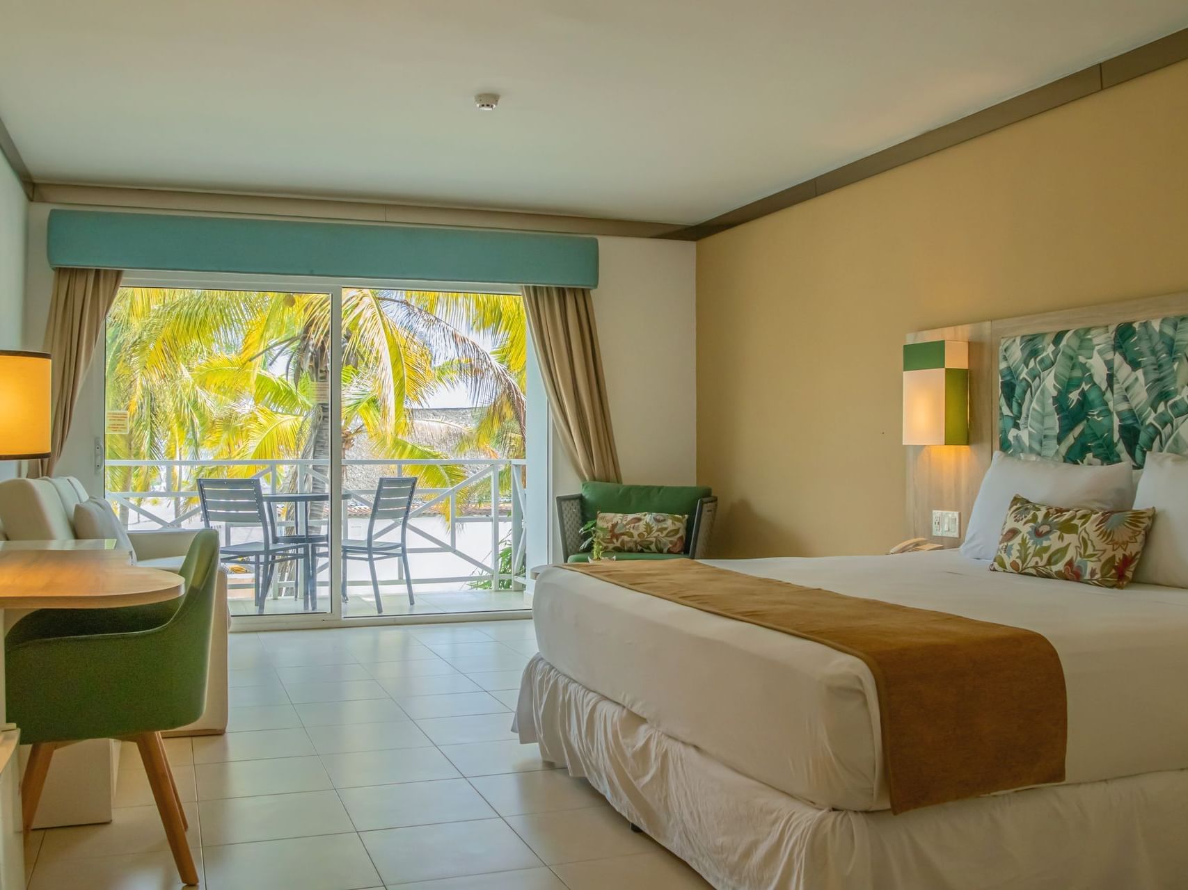 Ocean View room with balcony overlooking palm trees and tropical scenery at Playa Blanca Resort in Rio Hato
