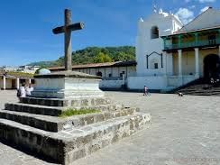 Cross statue by Saint James the Apostle Church on a sunny day near Porta Hotel del Lago