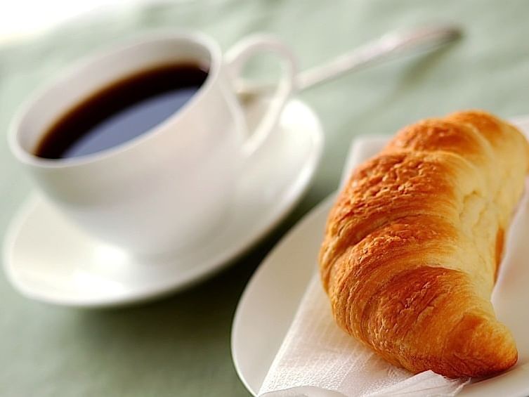 Coffee and croissant served at Carriage House Hotel