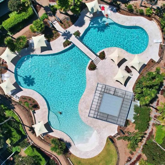 Aerial shot of lagoon pool with beautiful gardens surrounding