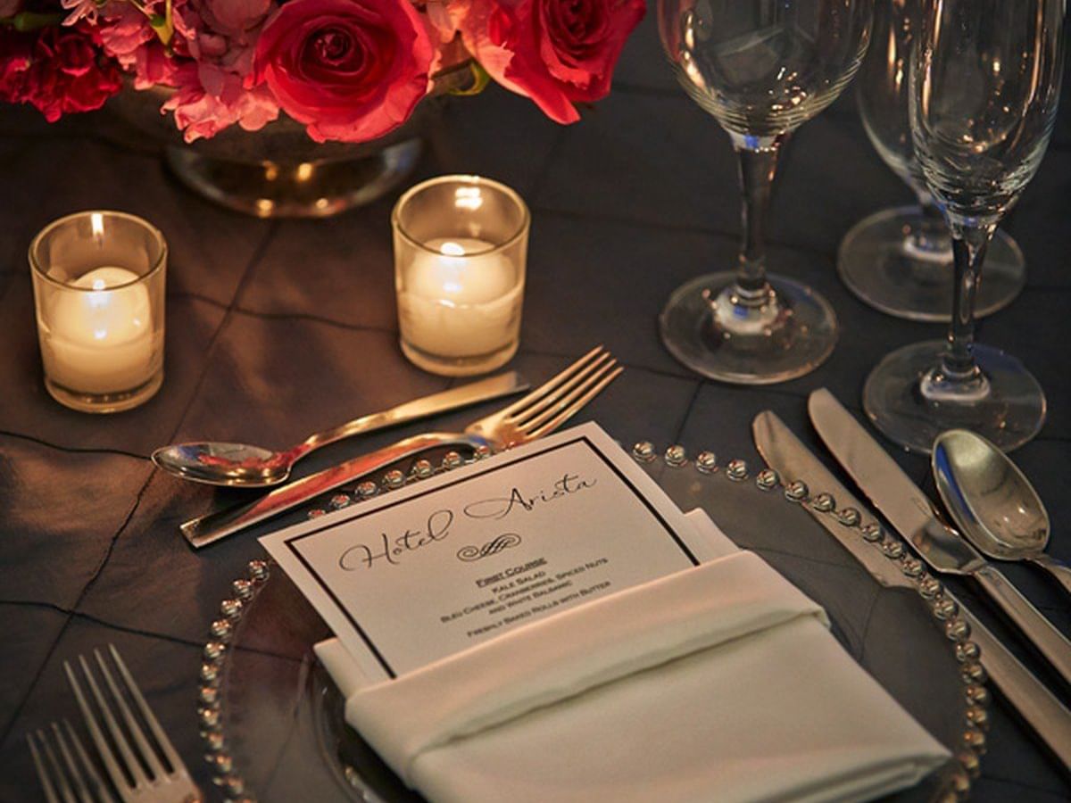 Set table with candles and floral centerpiece at Hotel Arista in Naperville.