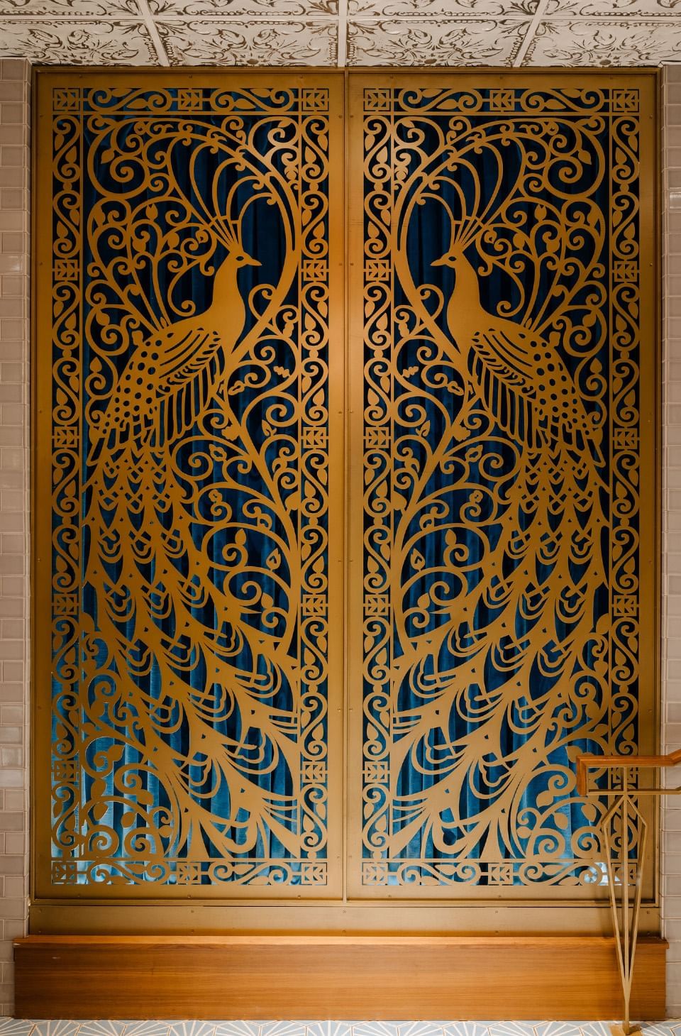 Gold peacock-patterned screen with fine swirls at Hotel Bijou, one of the top hotels in Downtown San Francisco
