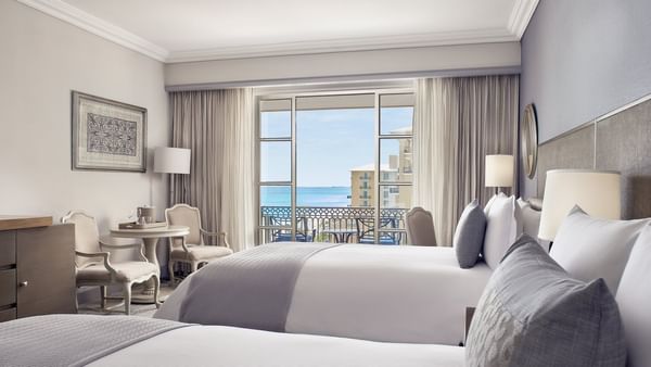 Sitting area facing the cozy beds in Deluxe Seaside Double Room at Kempinski Hotel Cancún