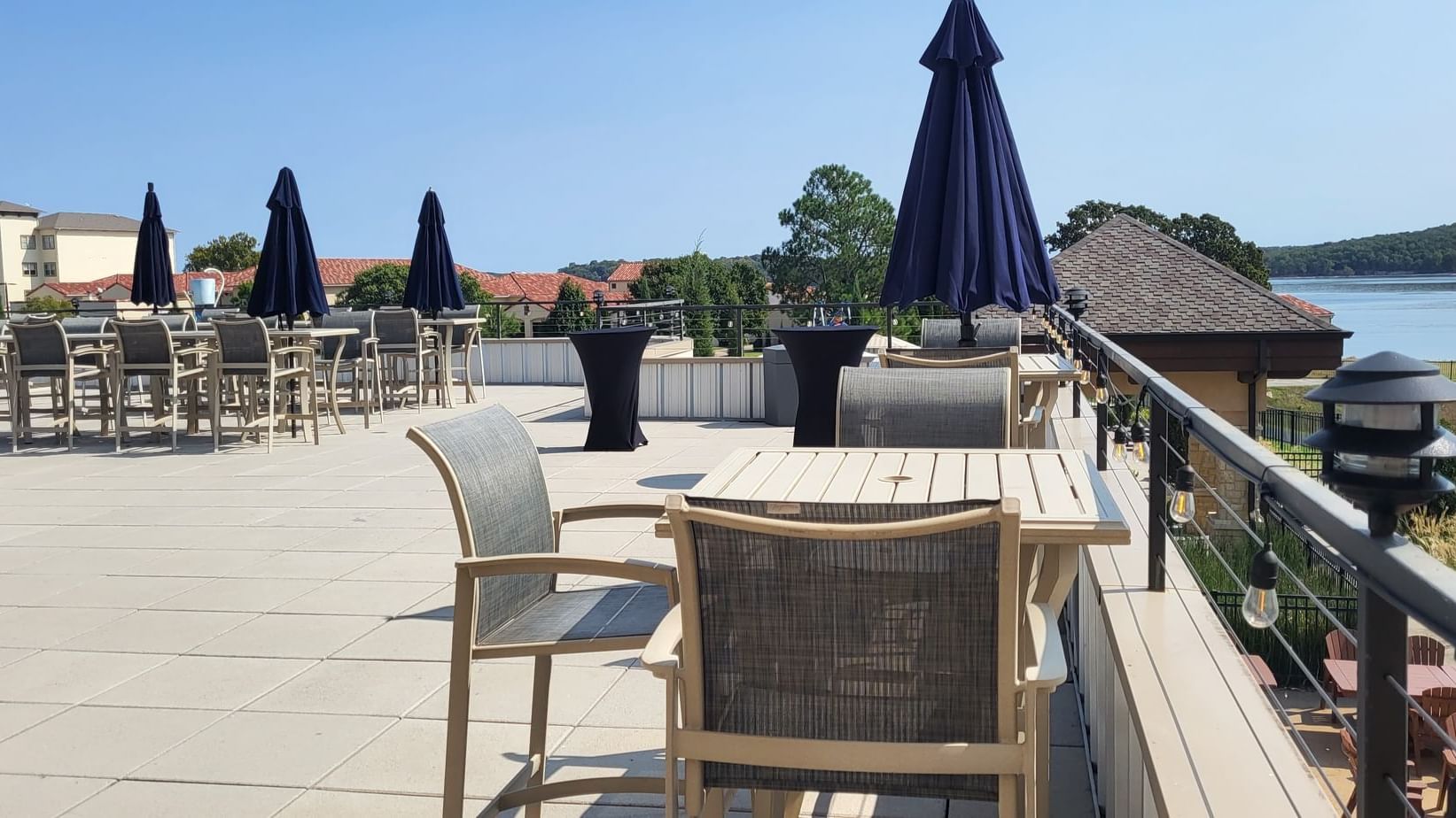 Rooftop Patio with tables, chairs, and dark umbrellas at Shangri-La Monkey Island