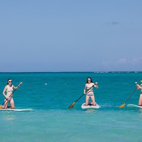 Ladies paddle boarding at the sea near Somerset Grace Bay