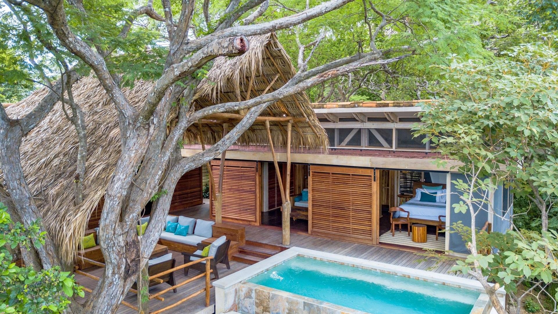 Free picture: Nautical room with a bed floating on a pool and with shelves  on wall with bottles of alcohol drinks, image size:1920x1080