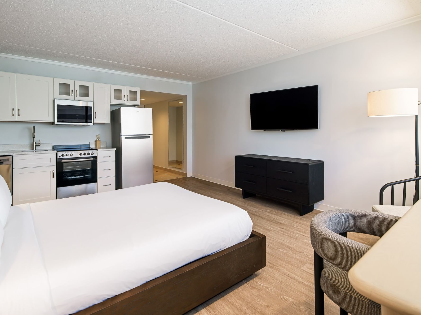 Studio apartment with king bed, kitchenette, seating area, and wood-style flooring at Showboat Hotel & Resort Atlantic City.