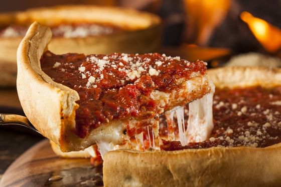 Close-up of a deep dish pizza slice near Kinzie Hotel