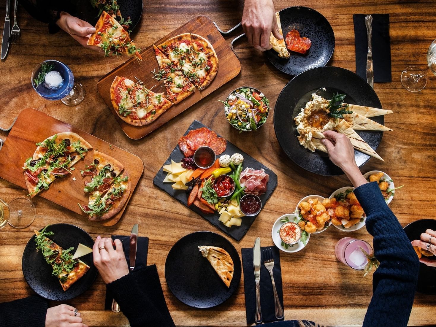 people sharing a meal, flatbreads, snacks