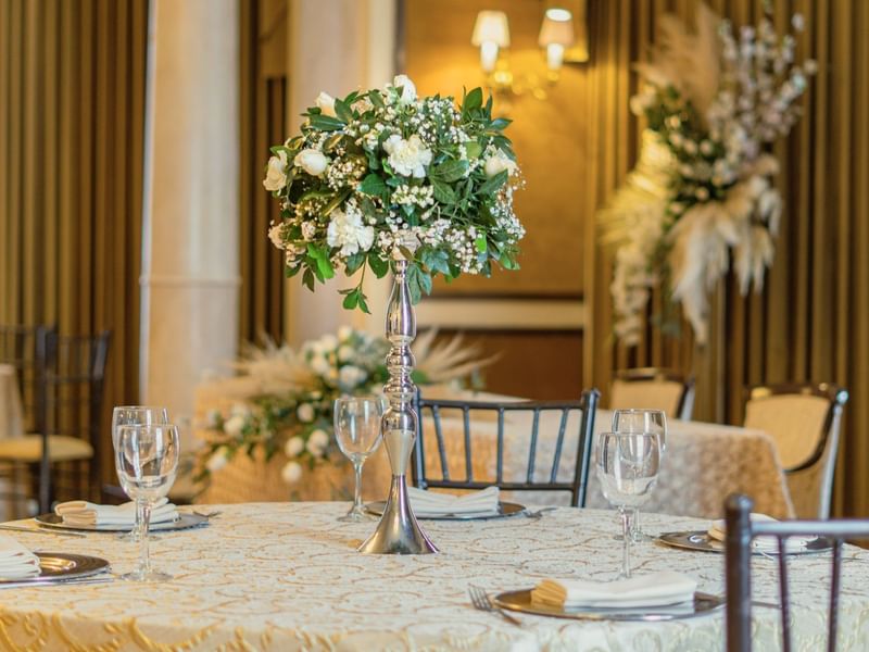 Close-up of floral decors on a table in Luis XV at Gamma Hotels