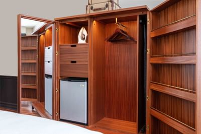Wooden closet by the bed in Garden View Rooms at Portland Harbor Hotel