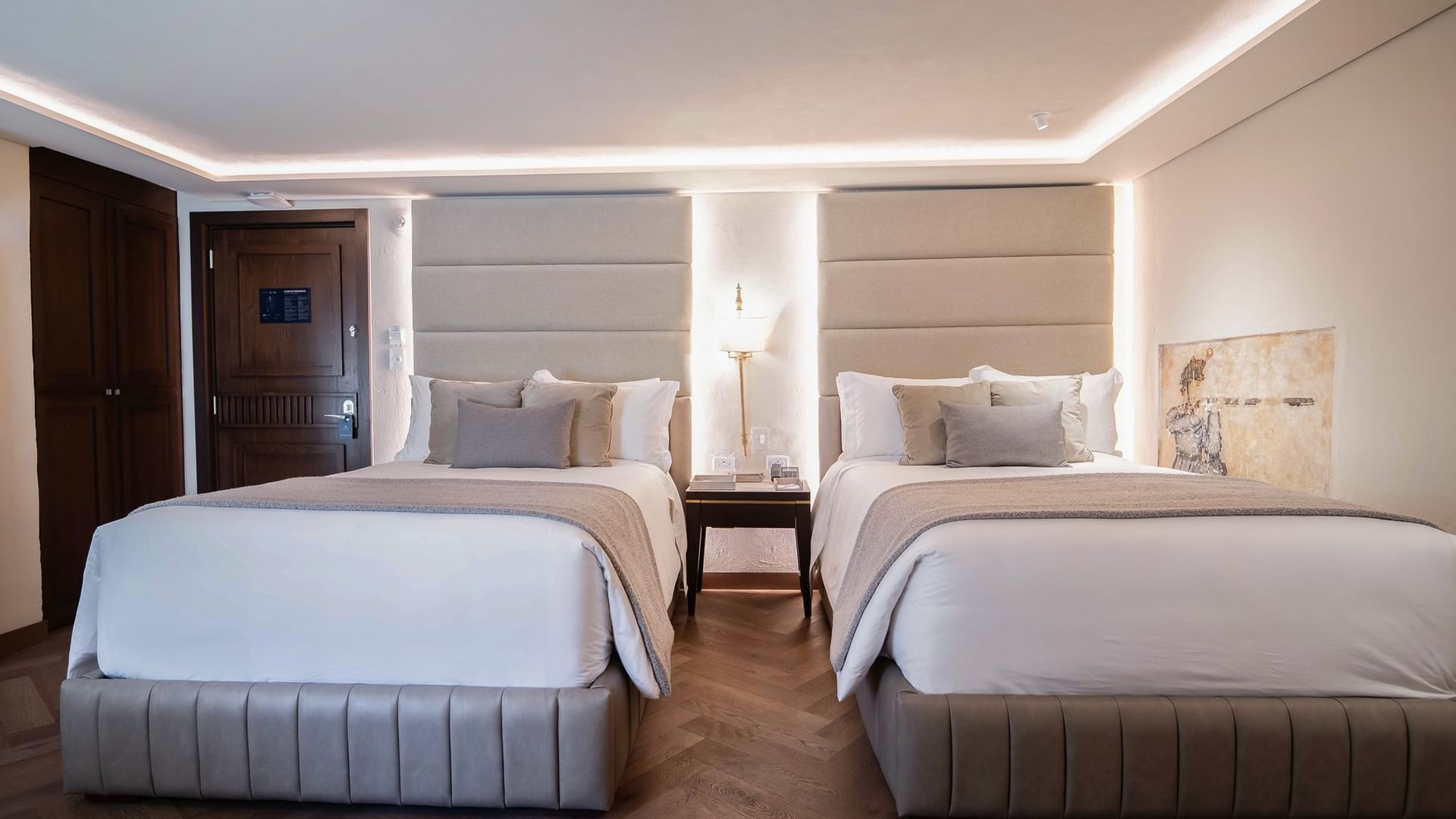 Two elegant beds with pillows and nightstands in a luxurious room at Quinta Real Puebla, Heroica Puebla de Zaragoza.