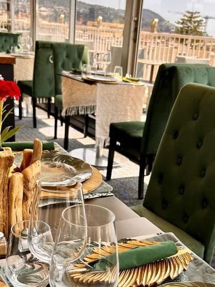 The Jungle Restaurant table setting featuring decorative wooden centerpieces and greenery at Splendid Hotel & Spa Nice