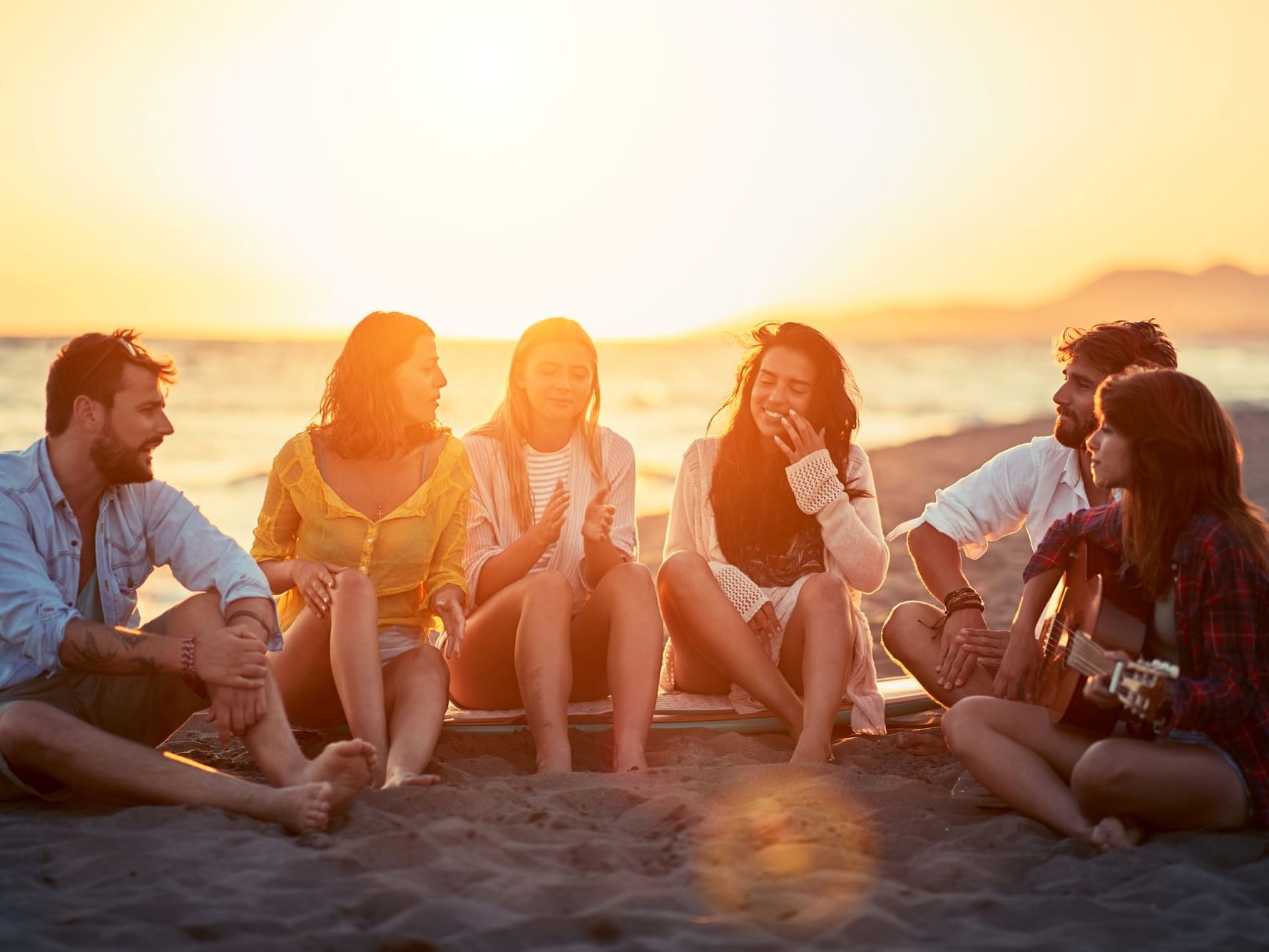 Friends in beach at sunset