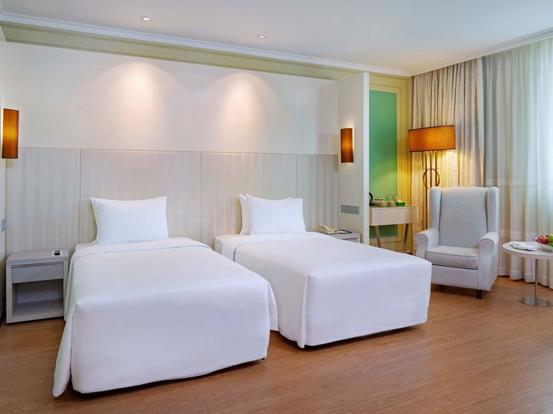 hotel room with twin bed and lounge chair