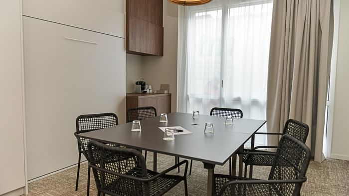 Salle de réunion élégante avec table et chaises au Hôtel Rivella.