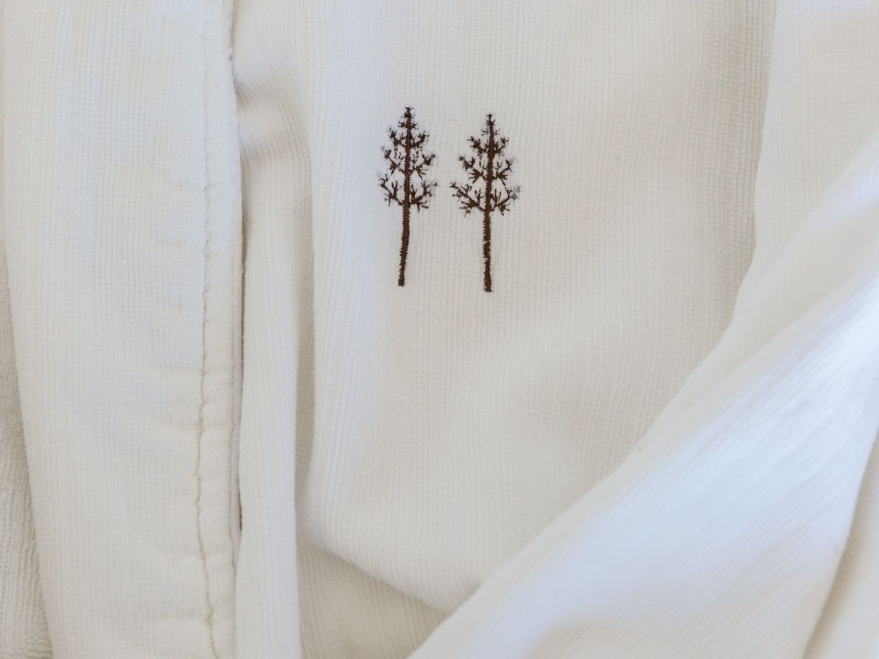 Heritage House Resort logo stitched to a white bathrobe