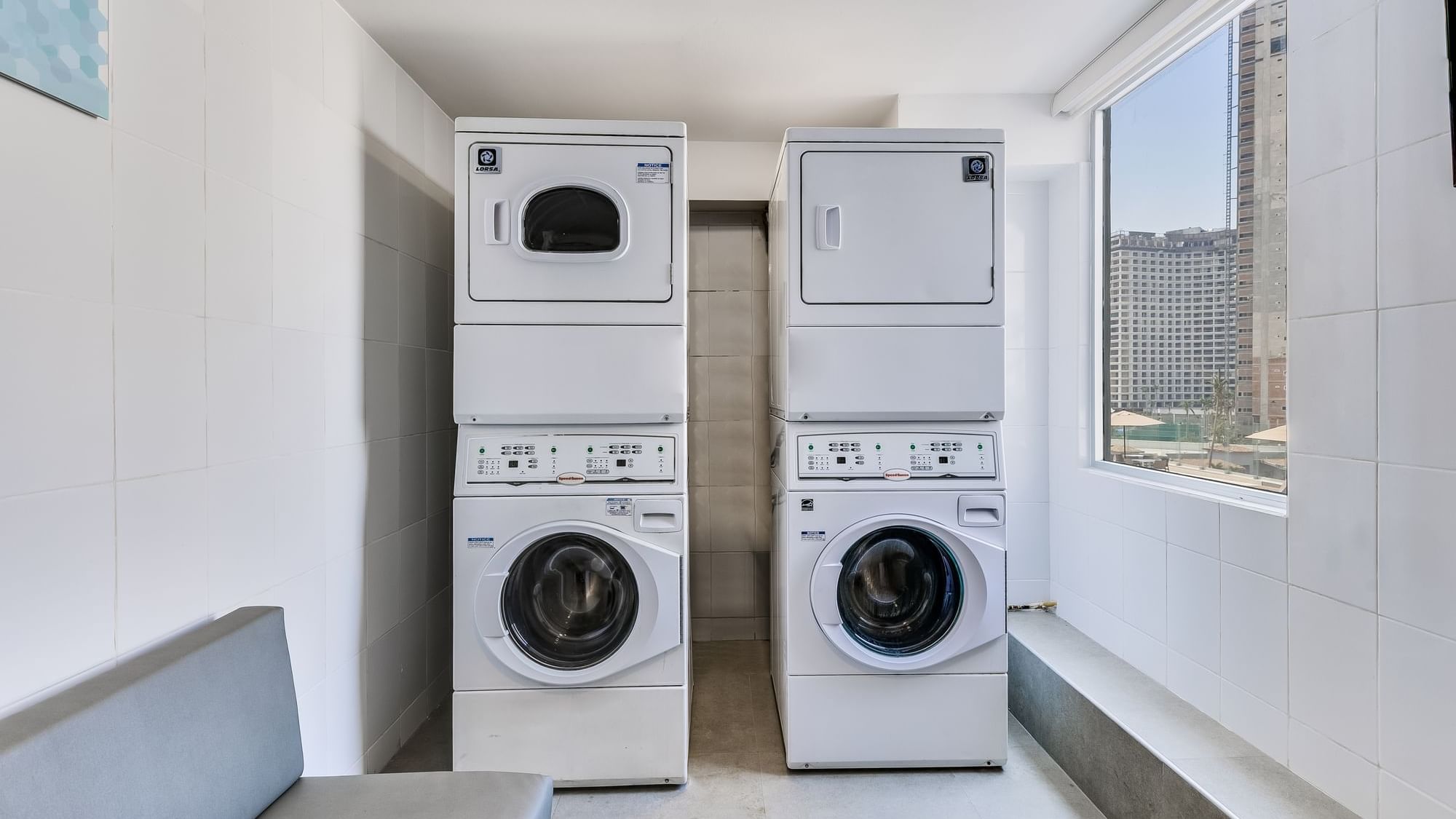 Washer and dryer in a cozy room at One Acapulco Costera