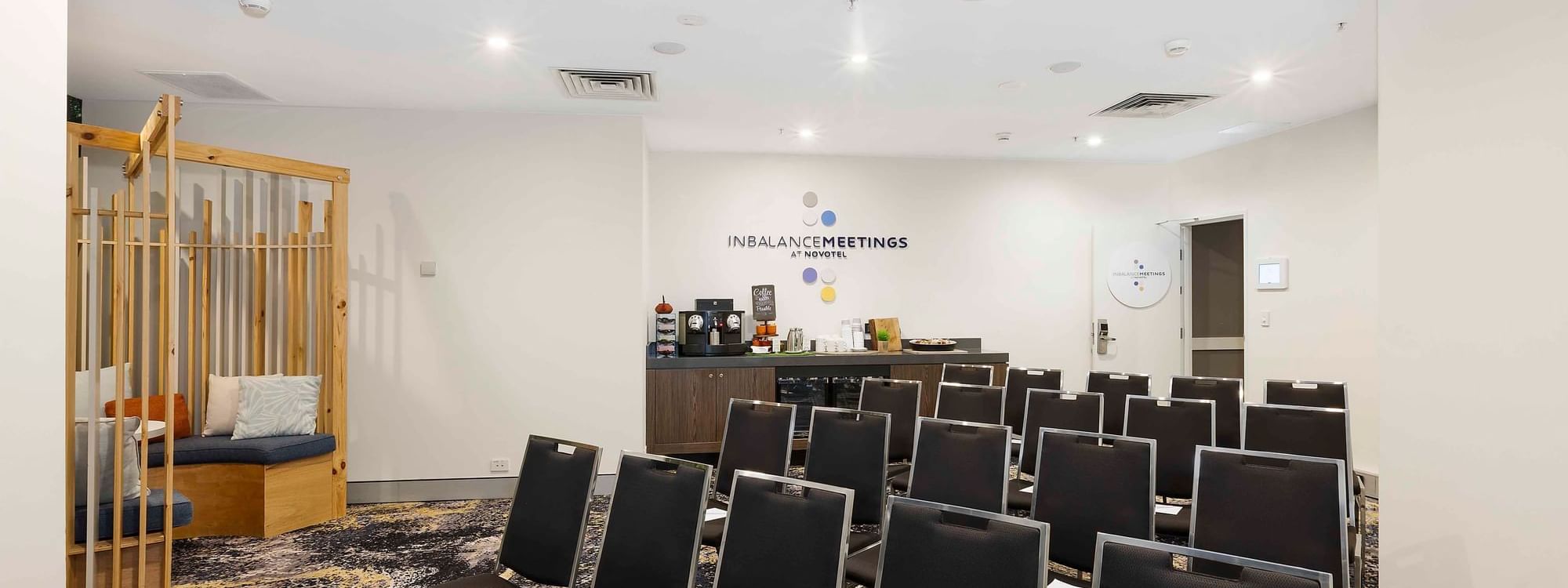 Theater-style table set-up with refreshment station in The McLaren Room at Novotel Sydney on Darling Harbour