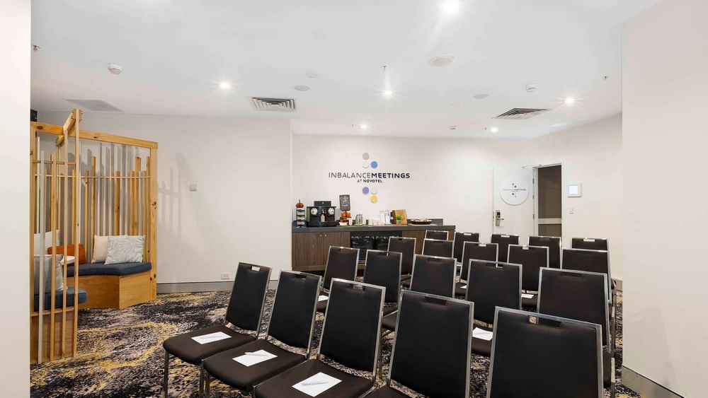 Theater-style table set-up with refreshment station in The McLaren Room at Novotel Sydney on Darling Harbour