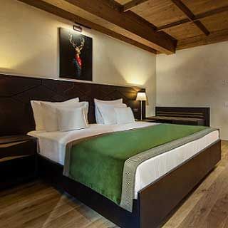 Bed with wall art in King Balcony Room at Ana Hotels Bradul